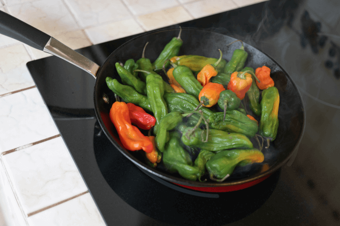 Heat your pan, and then add olive oil.  Add the peppers when the oil is hot but not burning.